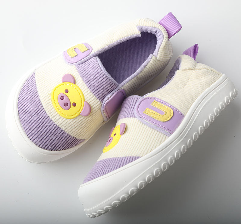 Pair of children's shoes with purple accents and cartoon character design on a light gray background